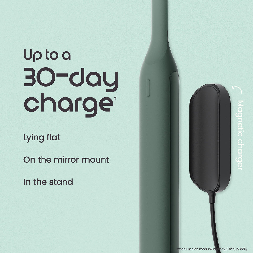 Green electronic device with magnetic charger on a light blue background